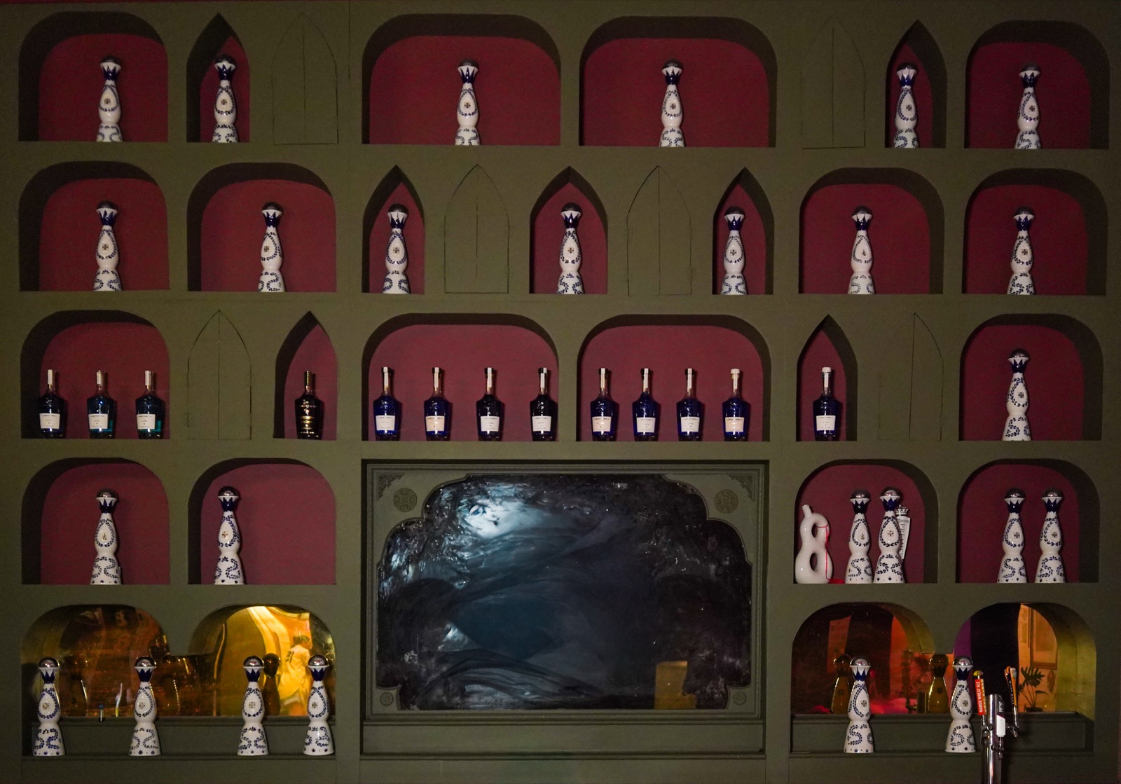 Detail of the arched bottle display behind the bar
